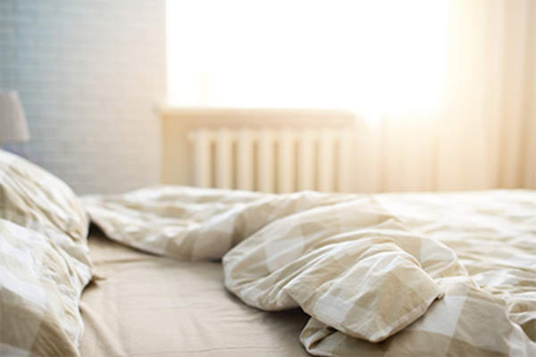 Unmade bed in the morning.