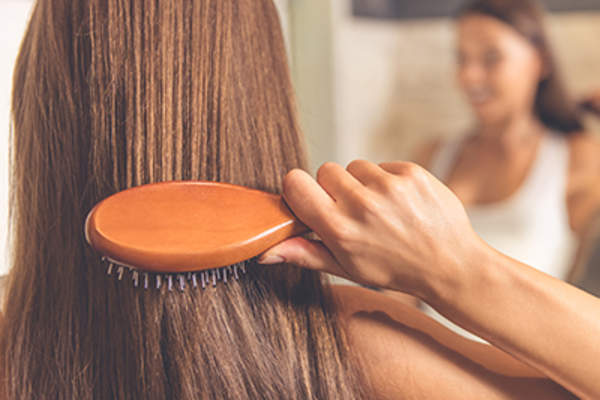 Woman brushing her hair.