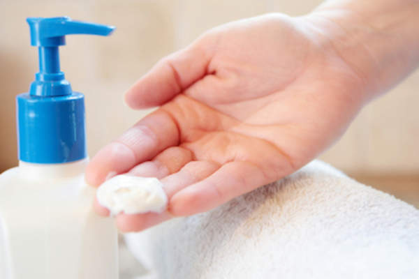 Large glob of lotion in hand.