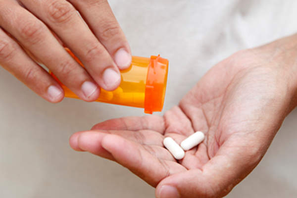 Prescription supplement in a woman's hand.