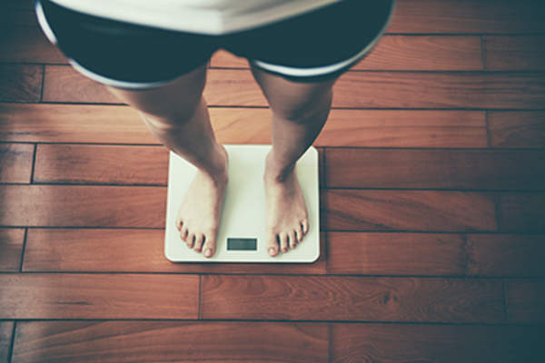 Standing on a scale.