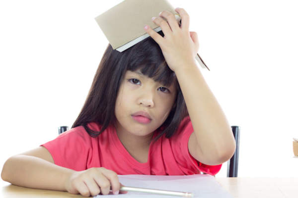 Young student overwhelmed by assignment.