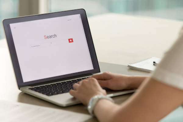 Woman with search screen open on laptop.