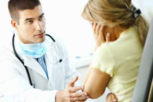 Doctor consoling patient.