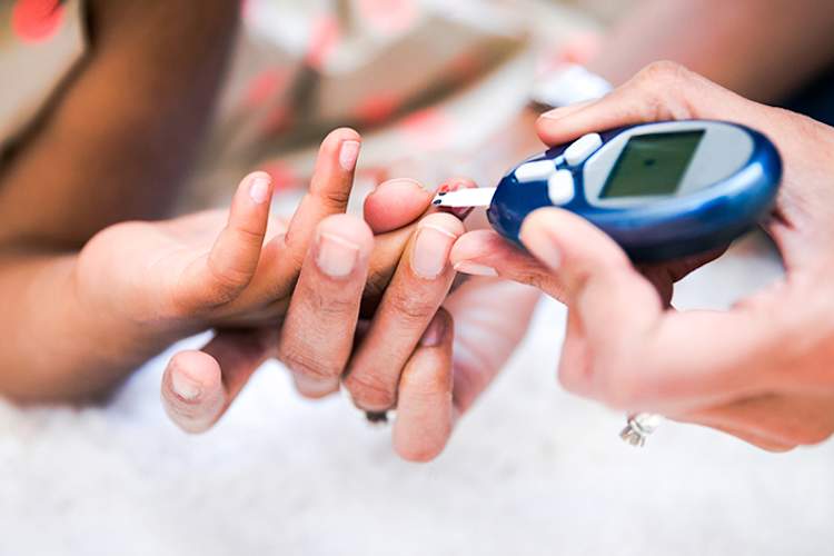 Child having blood sugar test.