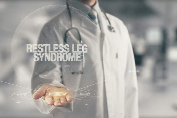 "Restless leg syndrome" holographic text in doctors hands.