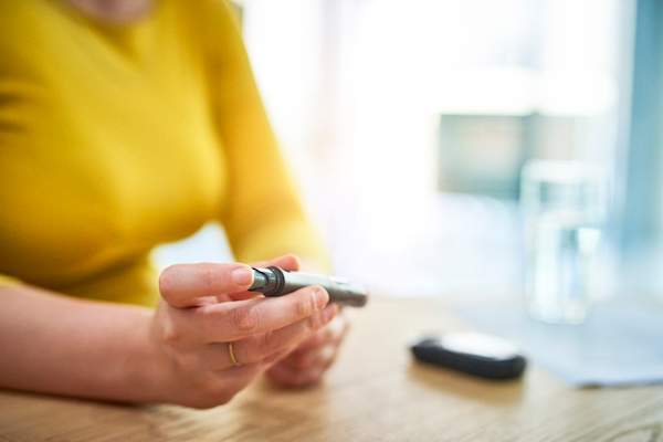 woman testing blood sugar