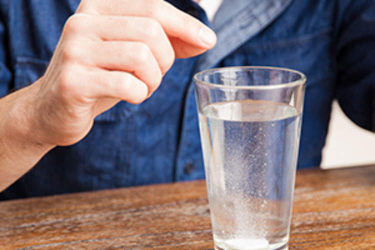 Tablet dissolving in a glass of water
