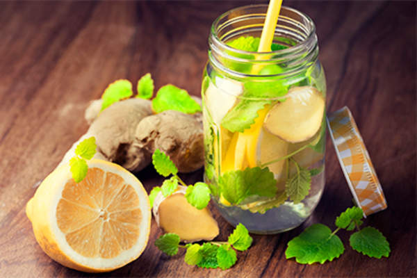 Glass of water with ginger and lemon.