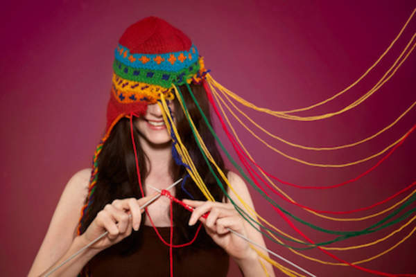 Woman knitting her own cap.