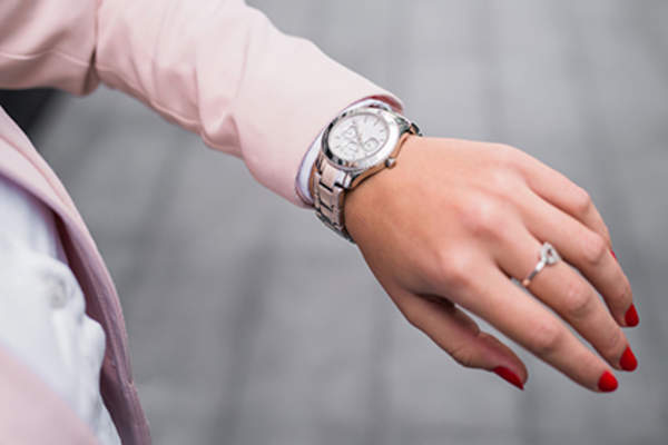 Woman checking her wristwatch.