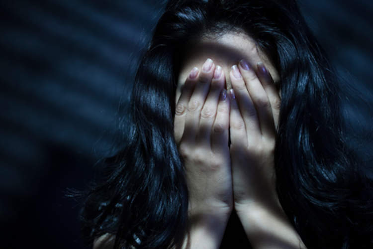 Woman hiding face