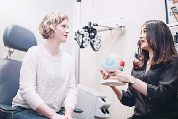 Female eye doctor talking to woman about eye health.