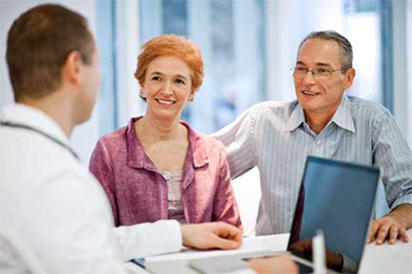 Mature couple talking to the doctor.