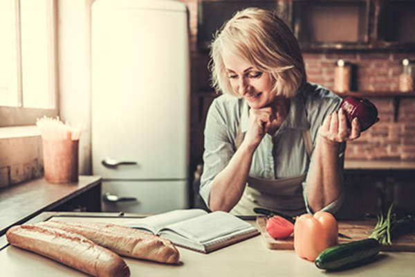 Middle age woman cooking.