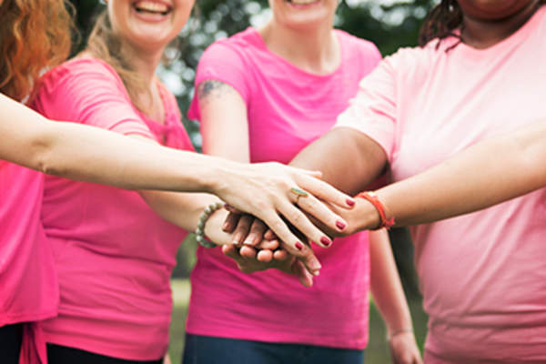 Cancer survivors with their hands in.