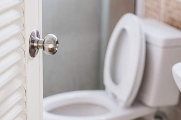 Opening the door to a bathroom.