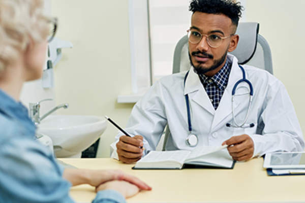 Female patient talking to a doctor.