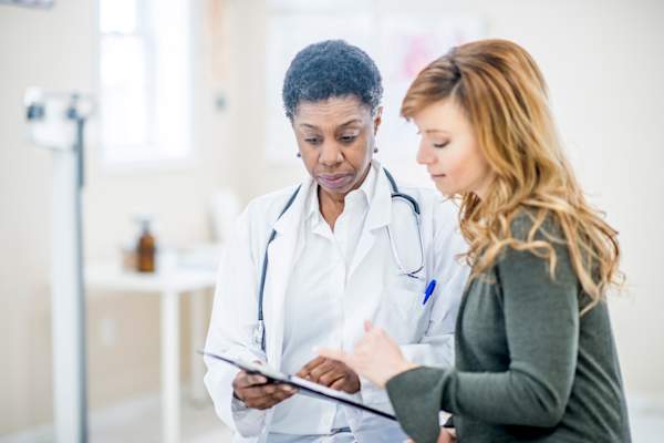Talking to doctor about symptoms.