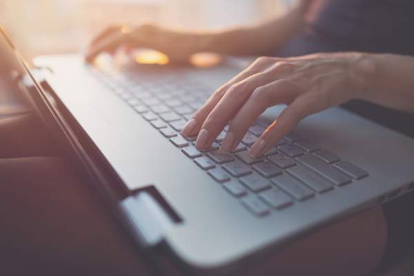 Woman blogs on her computer.
