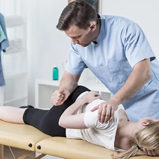 Chiropractor manipulating a woman's spine.