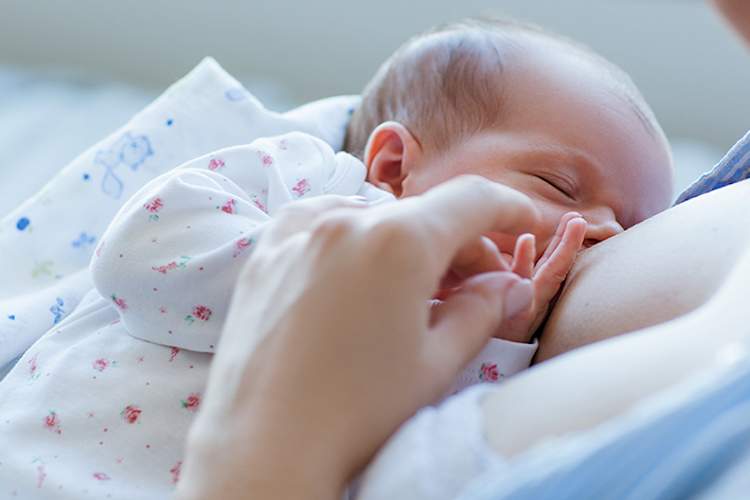 Mother breastfeeding a baby.