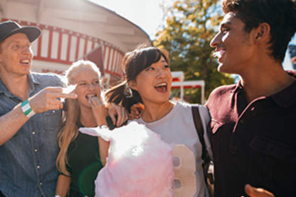 Couples eating cotton candy at the fair image.
