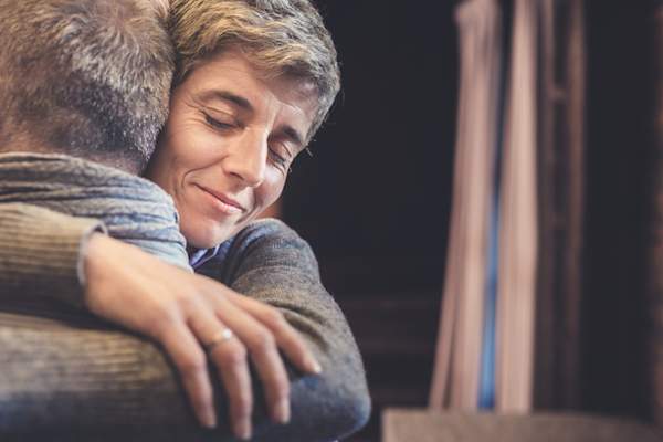 Married couple hugging.