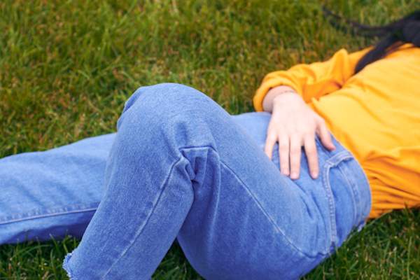 woman laying down wearing jeans
