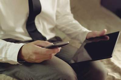 man with smart phone and tablet