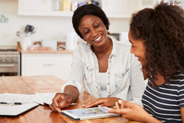 Mother helping daughter with homework.