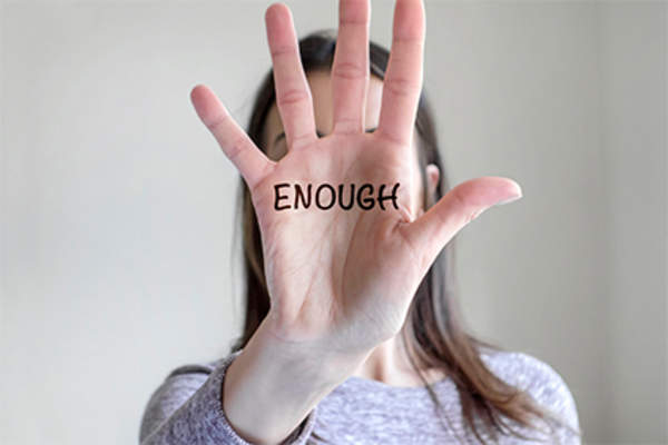 Word enough written on woman's hand.