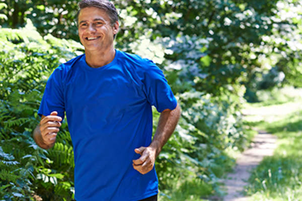 Middle age man jogging outside.