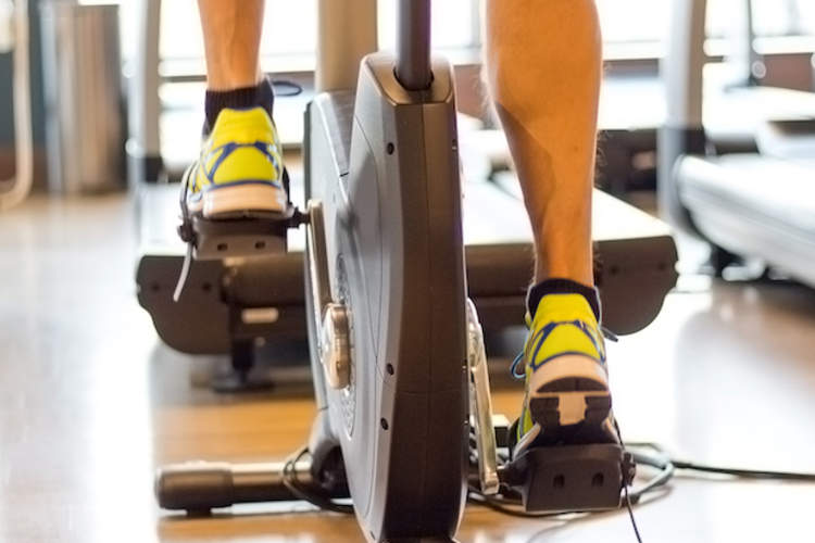 A woman exercises on a stationary bike.