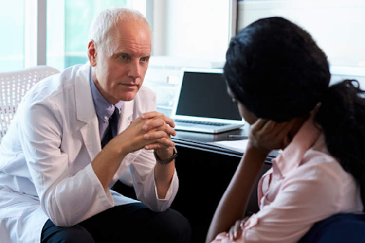 Woman in conversation with doctor.