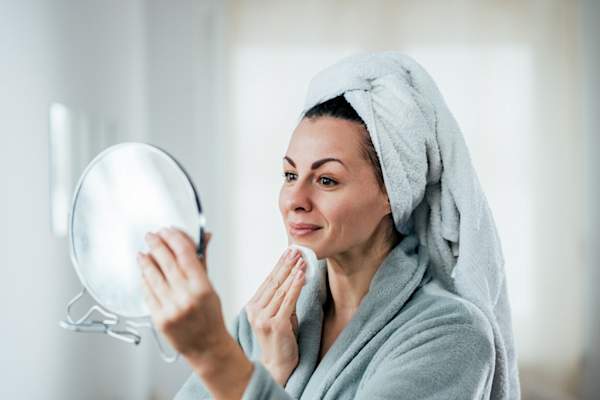 mature woman cleaning skin