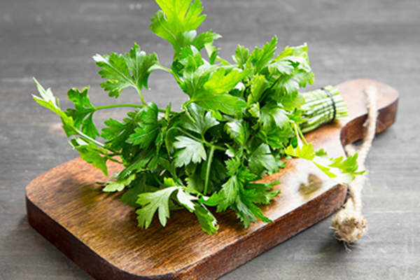 Parsley on a cutting board.