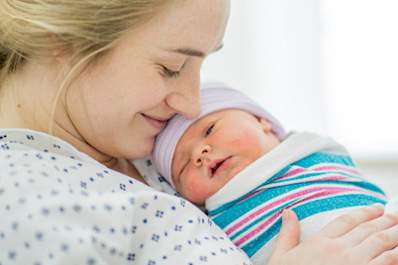 A mother holds her newborn baby.