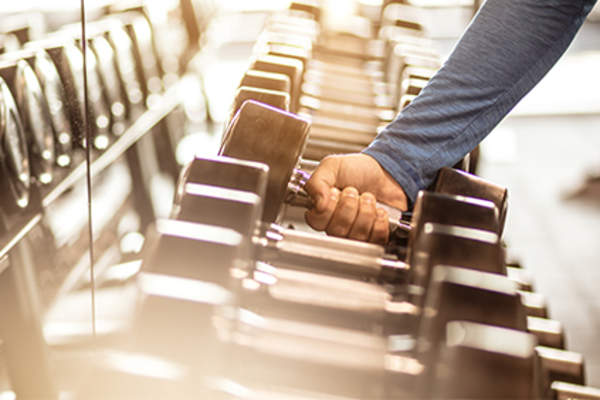 Man taking a weight at the gym.