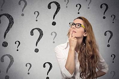 Woman thinking with question marks around her.