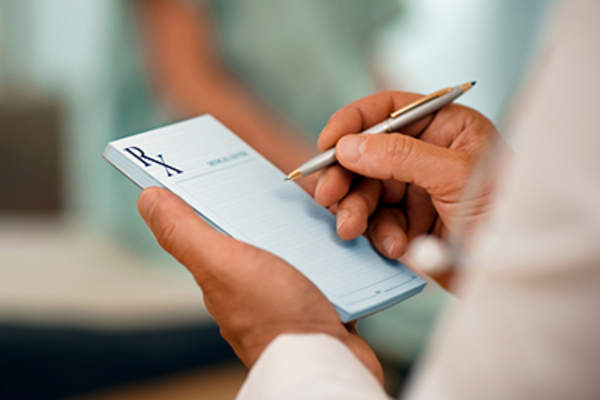 Doctor writing a prescription.
