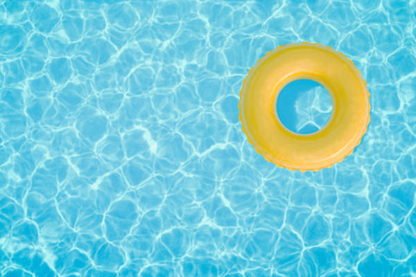 Yellow inner tube floating in pool.