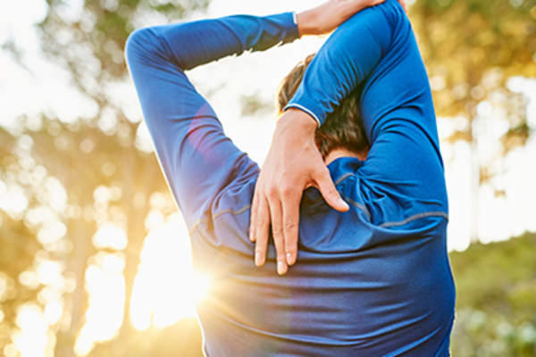Man stretching outside.