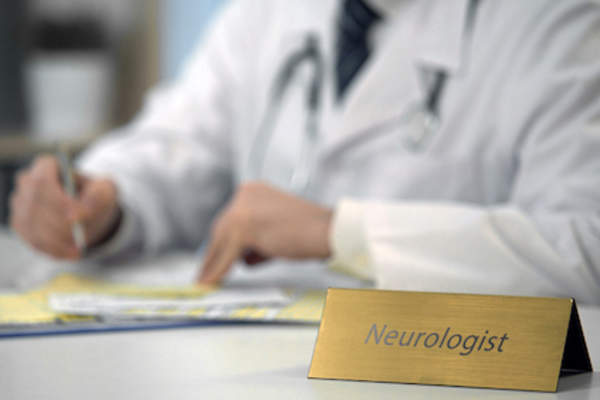 Neurologist at desk.
