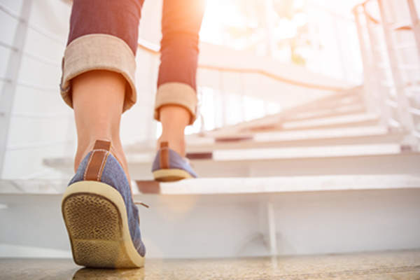 Woman walking upstairs.