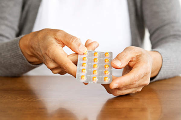 Mature woman taking medication