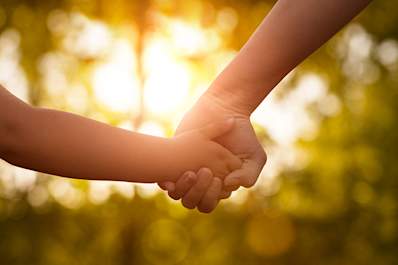 Mother holding her child's hand.