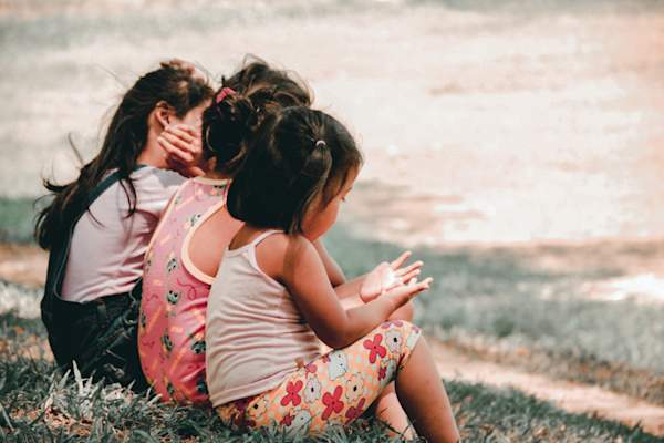 three young children sitting together