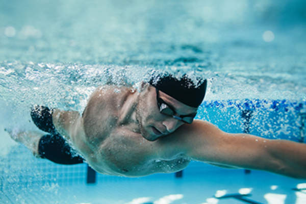 Man swimming in a pool.