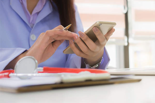 Woman using medical app on smartphone.